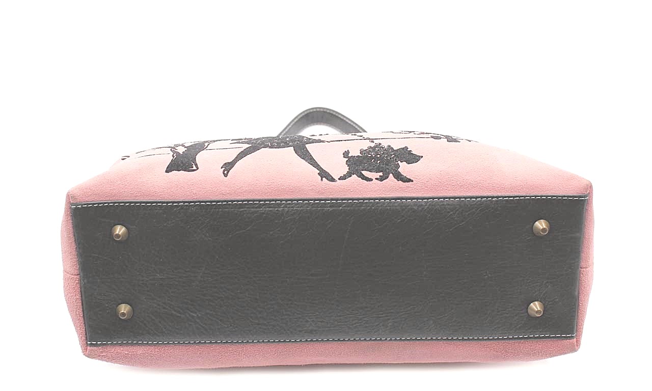 Isabella Fiore pink suede Handbag depicting a woman strolling through a park with a small dog on a leash.