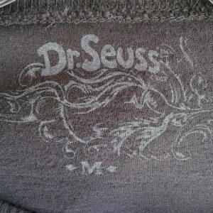 label of Dr. Seuss whimsical face with large eyeglasses.
