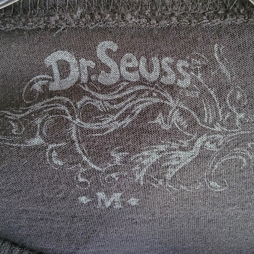label of Dr. Seuss whimsical face with large eyeglasses.